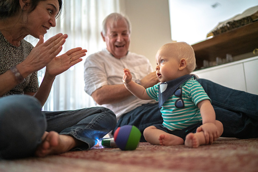 Grandparents playing with grandson