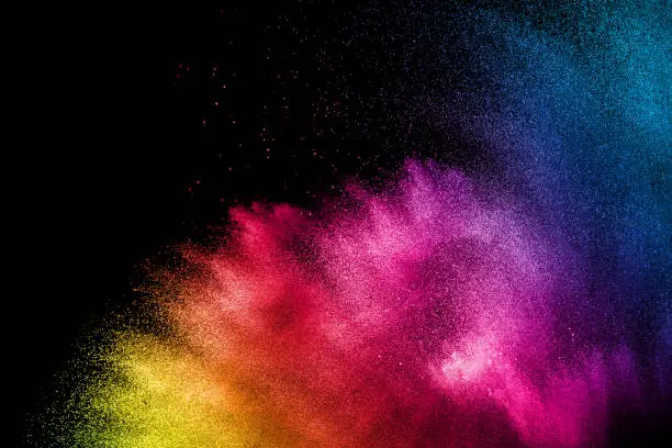 Photo of Colorful background of pastel powder.Multi colored dust splash on black background.Painted Holi.