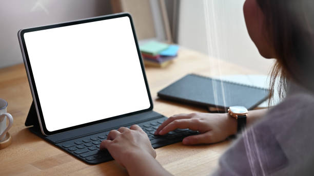 istock Young woman using isolated screen of tablet on table. 1174831829
