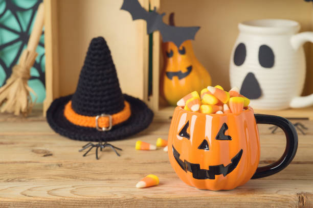 istock Halloween holiday concept with jack o lantern cuo and candy corn on wooden table 1174832064