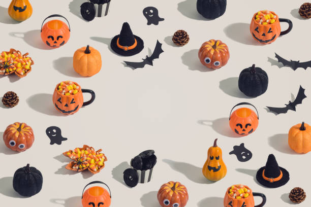 Halloween holiday creative background with jack o lantern, glitter pumpkin, candy corn and decorations