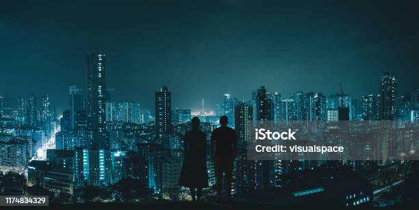 Couple Looking At City Skyline Stock Photo - Download Image Now - City, Night, Futuristic