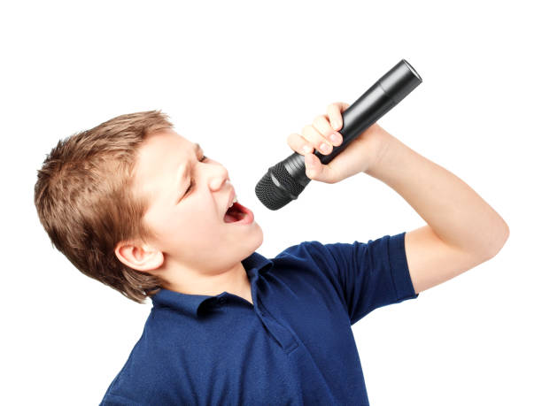 istock Teenage boy singing into a microphone. Very emotional. 1174836050