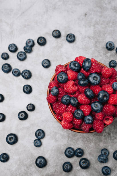 istock clay plate with tasty bright raspberries on a gray background 1174836190