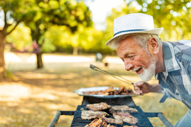 istock Senior Man at Barbecue party 1174836445