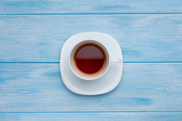 istock Top view cup of tea on blue wooden table 1174838599