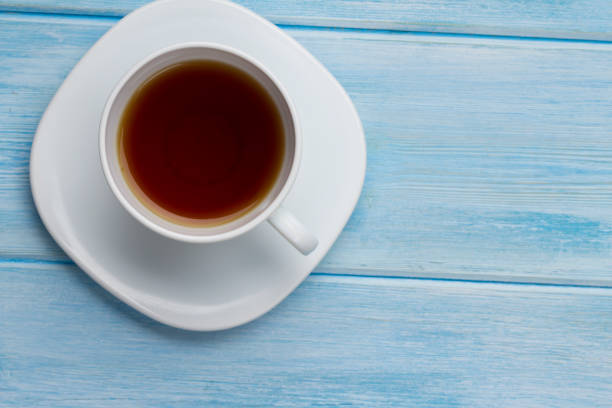 istock Top view cup of tea on blue wooden table 1174838600