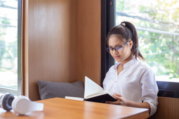 istock Female students at wearing glasses lovely reading test preparation. 1174841528