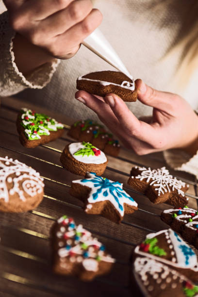istock Hand decorating Christmas gingerbread cookies 1174844389