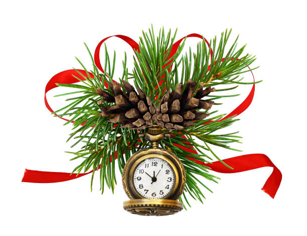 Christmas arrangement with pine twigs, cones small watch and red silk ribbon bow Christmas arrangement with pine twigs, cones small watch and red silk ribbon bow isolated on white snake wrapped around stock pictures, royalty-free photos & images