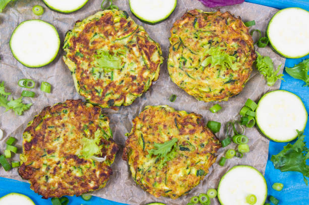 istock Zucchini pancakes with chives on a wooden table. 1174847196