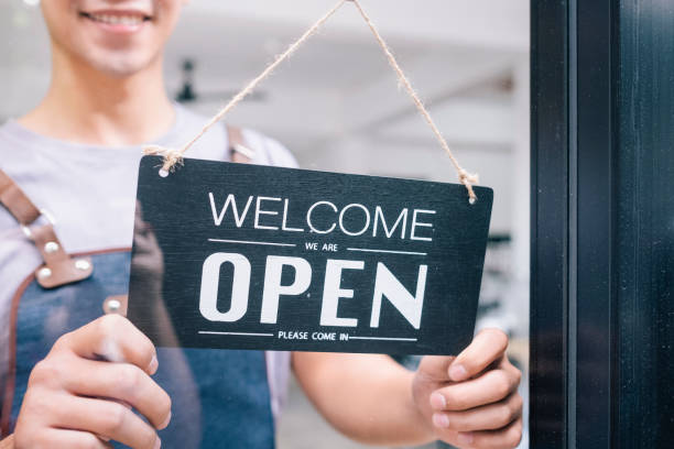 istock Young startup coffee cafe owener open and welcome customer. 1174848241