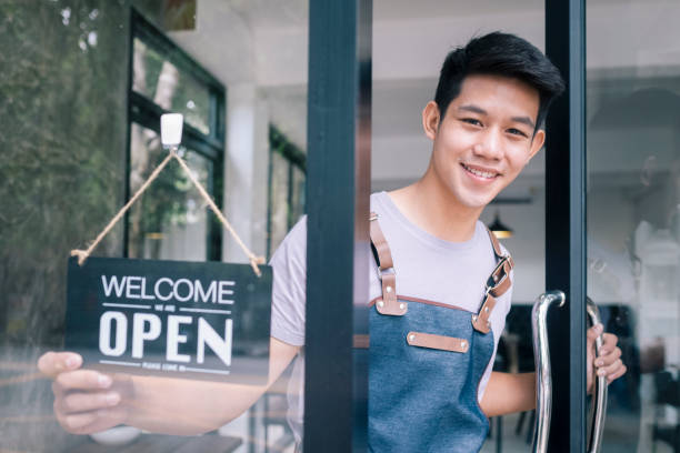 istock Young startup coffee cafe owener open and welcome customer. 1174848249