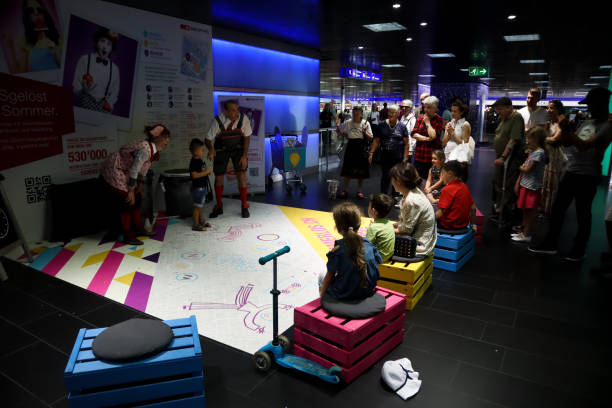 Interior of Zurich Main railway station, underground passage, group of artists performing show for kids with audience around them Zurich, Switzerland,July 21, 2019: Interior of Zurich Main railway station, underground passage, group of artists performing show for kids with audience around them zurich train station stock pictures, royalty-free photos & images