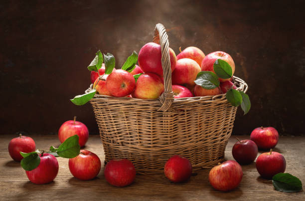 istock fresh apples with leaves in a basket 1174848389