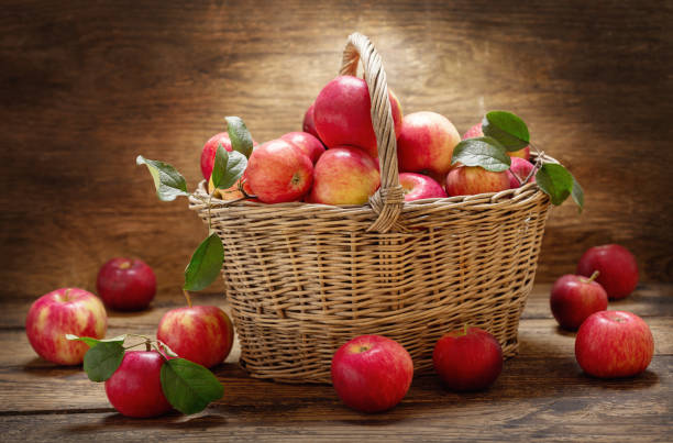 istock fresh apples with leaves in a basket 1174848392