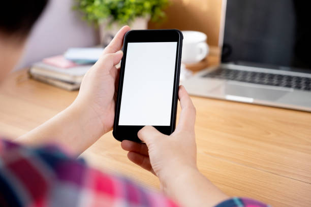 istock Closeup hands using smartphone mockup at the office desk. 1174848475