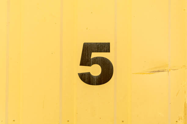 istock Number 5 stencilled in black on yellow background 1174850663