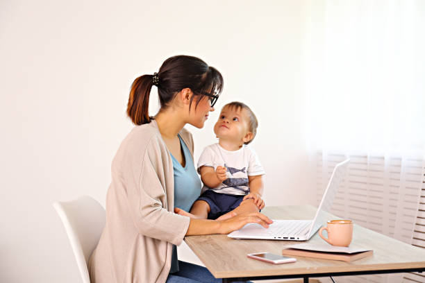 istock Young mommy working at home office and raising a child. 1174850886