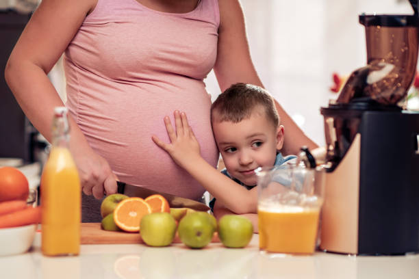 istock Mother and son making fresh orange juice 1174851087