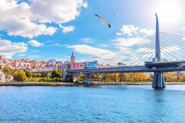 Photo of Halic Metro Bridge and Galata Tower on the background, view from the Golden Horn, Istanbul, Turkey