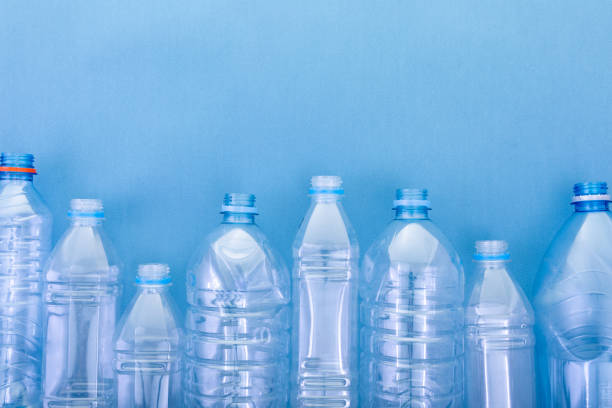 plastic bottles plastic bottles on a blue cardboard background. concept ecology and science above can drink high angle view stock pictures, royalty-free photos & images