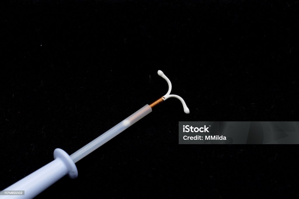 T shape IUD Gold hormon free Birth Control Pill Stock Photo