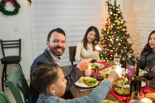 istock Happy Man Having Fun With Sparklers At Home In Christmas 1174858332