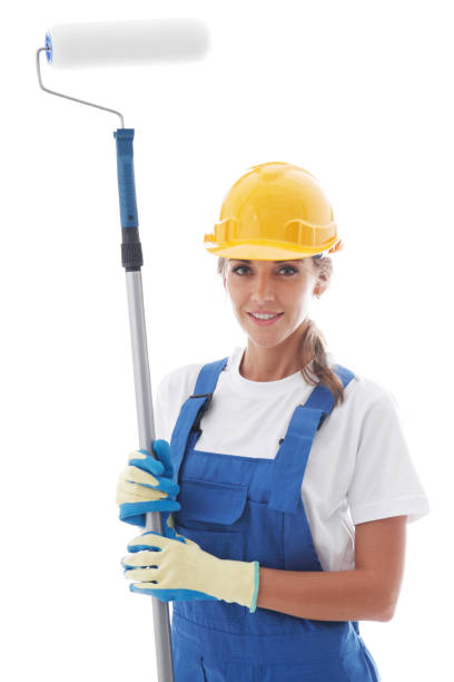 istock Handywoman with paint roller 1174858508