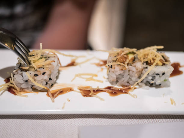 Typical Japanese dish of sakura roll on a white plate.