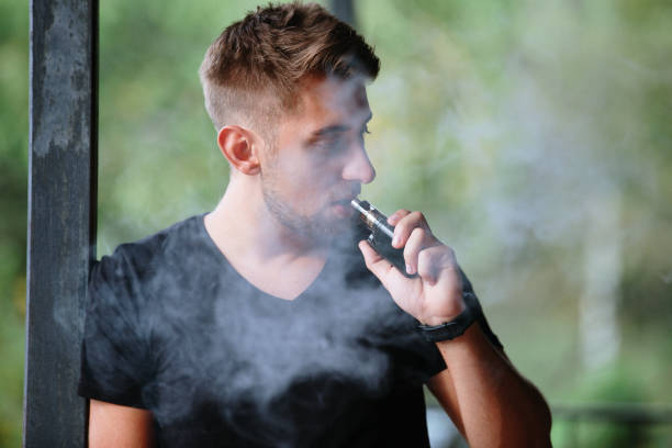 istock Young male worker smoking electronic cigarette 1174859860