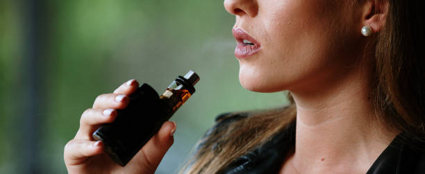 istock Closeup of woman smoking electronic cigarette 1174864280