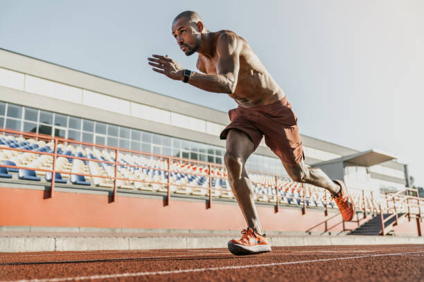 istock African runner athlete starting his sprint on running track at the stadium 1174864687