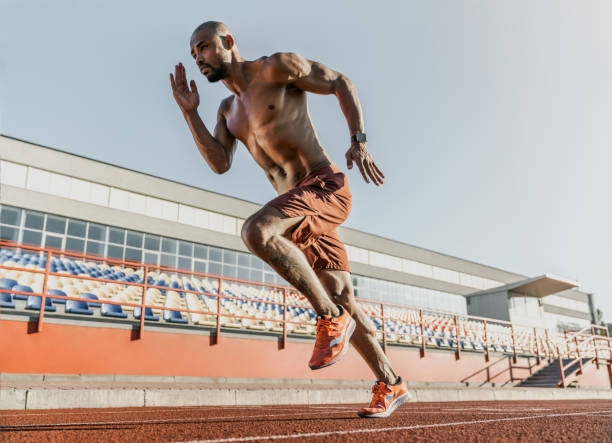 istock African runner athlete sprinting on running track at the stadium 1174864859