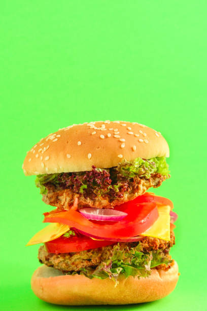 istock burger (roll, cutlets, cheese, lettuce, tomato, onion, sauce and more) menu concept. food background. copy space. Top view 1174865541