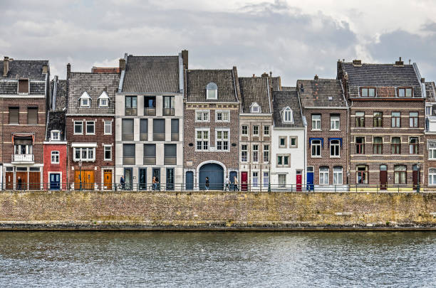 Maastricht, The Netherlands, September 7, 2019: row of houses in various sizes and materials on the qauy of the river Maas in Wyck district
