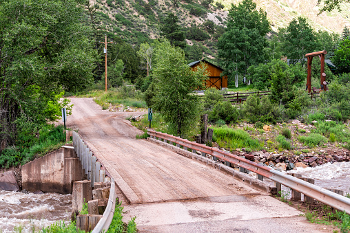Redstone, USA - July 1, 2019: Highway 133 in Colorado during summer with red bridge on Crystal river and ranch property