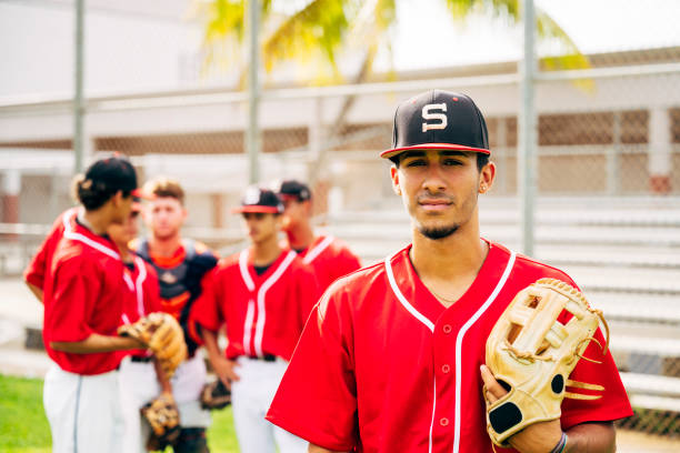 istock Serious Hispanic baseball player with glove waiting to play 1174867101