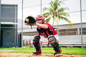 istock Baseball catcher crouching to catch pitch in center of mitt 1174867123