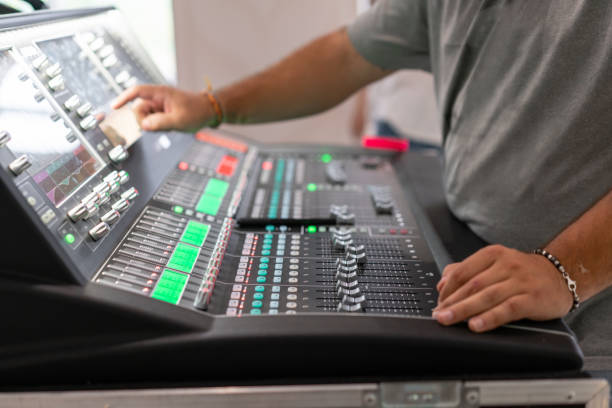 istock Male hand on control Fader on console. Sound recording studio mixing desk with engineer or music producer 1174870225