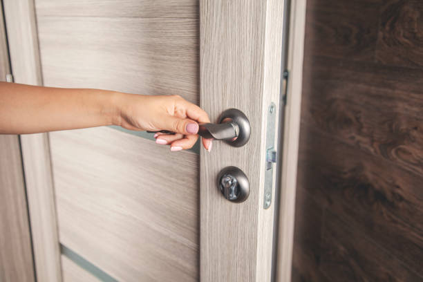 istock woman hand door 1174870435