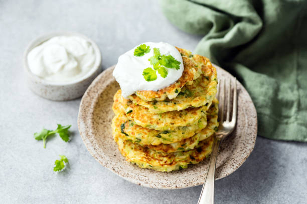 istock Zucchini pancakes or fritters with sour cream 1174870603