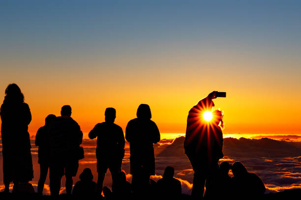 istock Silhouettes of people watching sunset 1174872713
