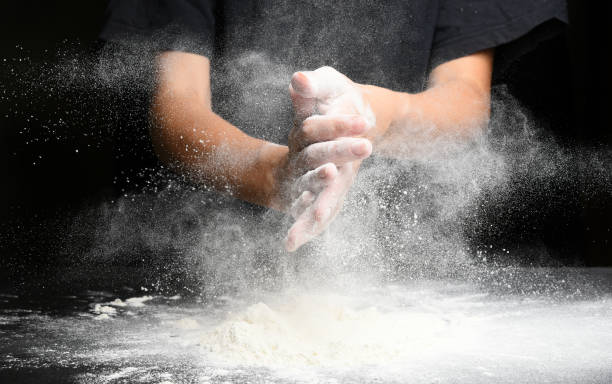 istock Woman chef hand clap and white flour 1174872904