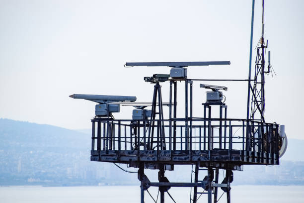 rotating antennas of a military radio station on tower. - sea safety antenna radar imagens e fotografias de stock