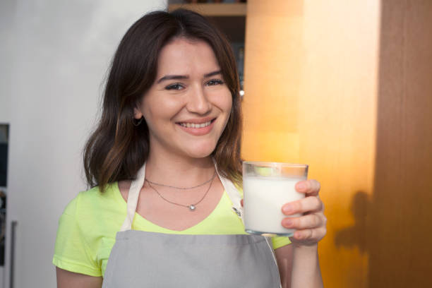 istock young woman drinking milk in the kitchen 1174881341