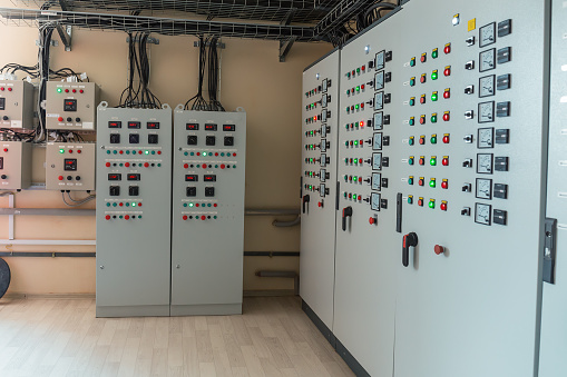 Electrical switch gear cabinets, control panels in factory.