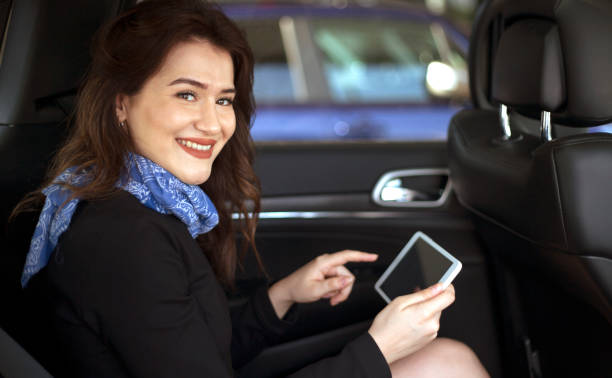 istock young woman using tablet pc in the car 1174881511