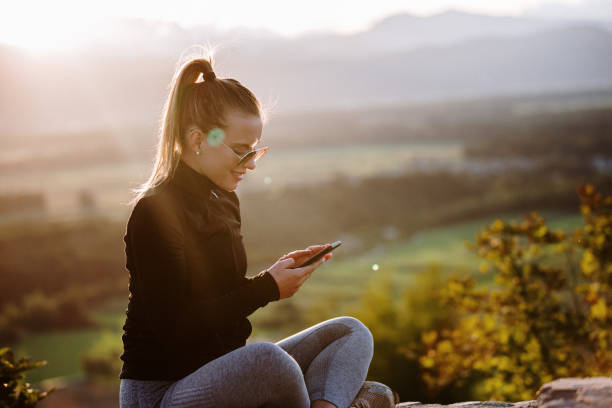 istock Sporty woman using phone 1174882477