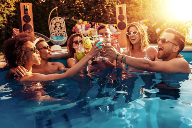 Enjoying Pool Party With Friends Stock Photo - Download Image Now - Pool Party, Swimming Pool, Party - Social Event - iStock